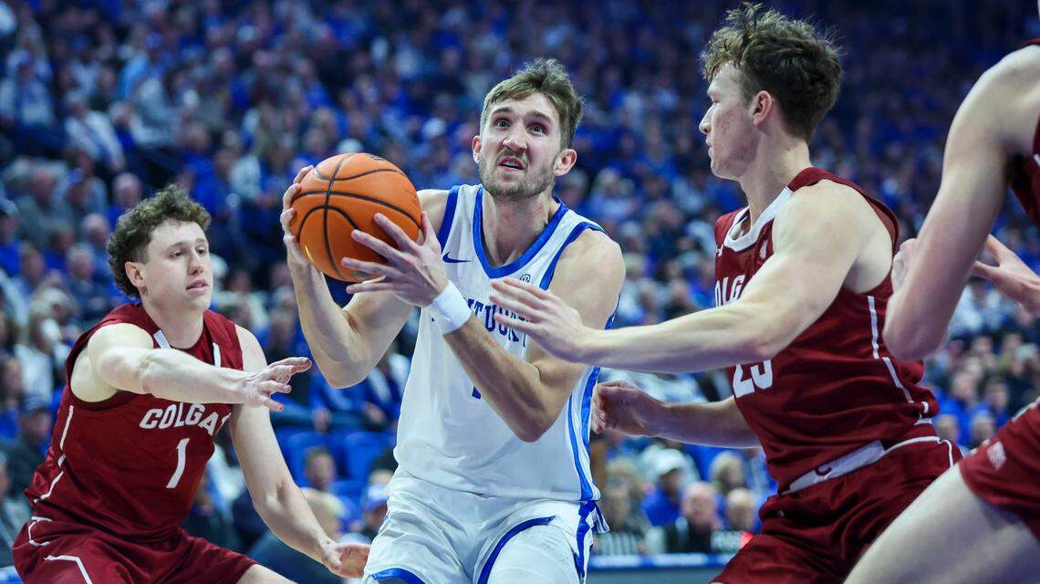 Kentucky forward Andrew Carr, center, drives to the basket past two Colgate defenders during Wednesday’s game at Rupp Arena.