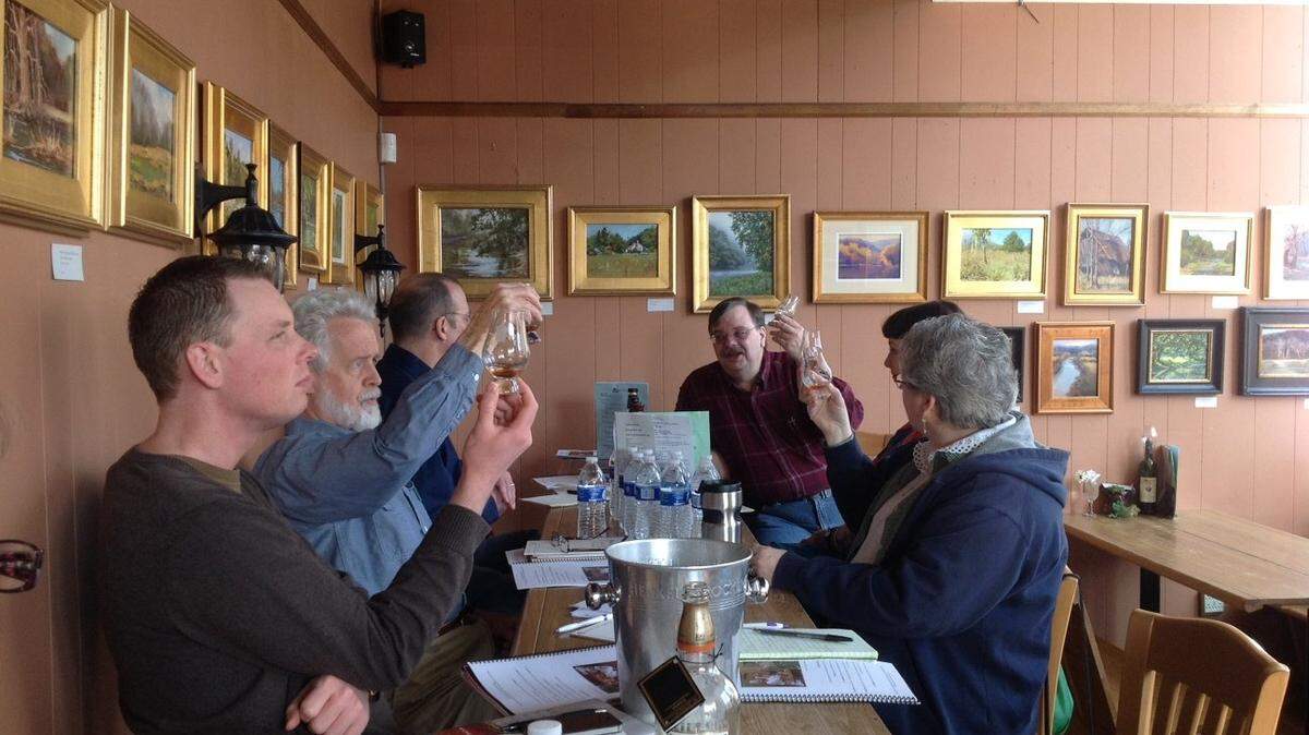 Students in the Filson Historical Society's Bourbon Academy, held April 6 at Capital Cellars in Frankfort, studied their glasses of bourbon. From left are Tim Knittel, George Fowler, Carl Shields, teacher Michael Veach, Molly Wellman and Jan Fowler. The eight-hour seminars cover the history of bourbon and include samples.    