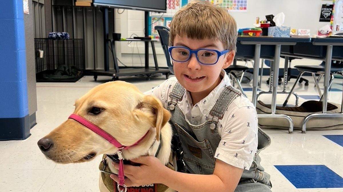 Colin Vaught with his service dog, Ally.