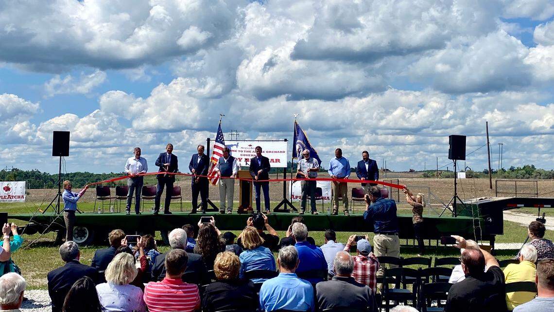 AppleAtcha founder Jim Booth, a former coal operator in Martin County, cut a ribbon to celebrate the opening of an apple orchard on a reclaimed surface mine on Tuesday, June 22, 2021.