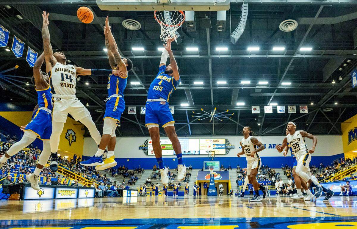 Murray State’s Justice Hall (14) tries to rebound against Morehead State’s Tray Hollowell, left, Skyelar Potter and Johni Broome (4) during the second half Saturday in Morehead.
