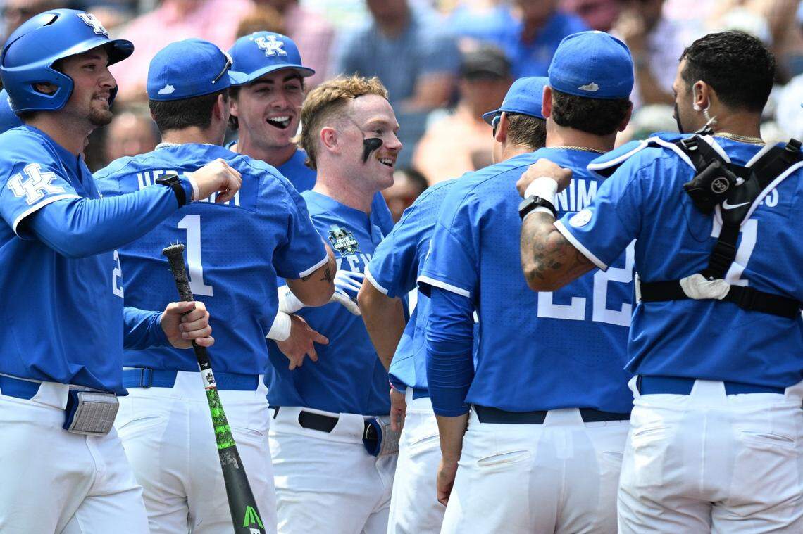 Jun 15, 2024; Omaha, NE, USA;  Kentucky Wildcats center fielder Nolan McCarthy (19) celebrates with the team after hitting a home run against the NC State Wolfpack during the fourth inning at Charles Schwab Filed Omaha. Mandatory Credit: Steven Branscombe-USA TODAY Sports