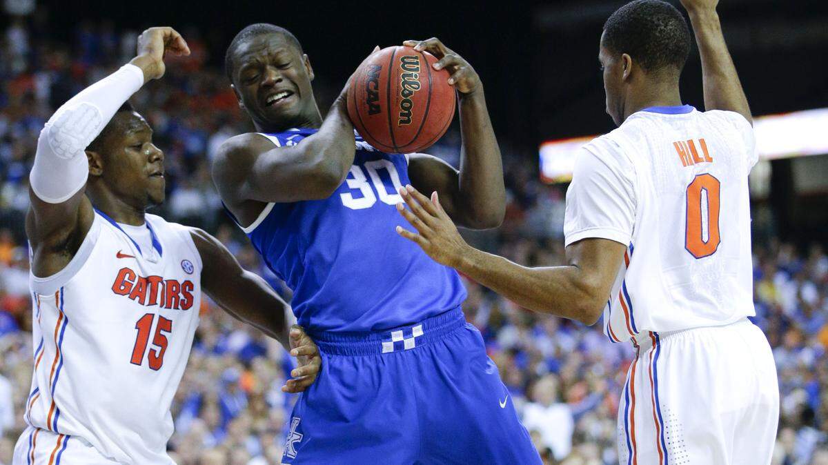 Kentucky Wildcats forward Julius Randle (30) fought through the lane against Florida Gators forward Will Yeguete (15) as Florida beat Kentucky 62-60  in the SEC championship on Sunday March 15,  2014 in Atlanta,GA. Photo by Mark Cornelison | Staff