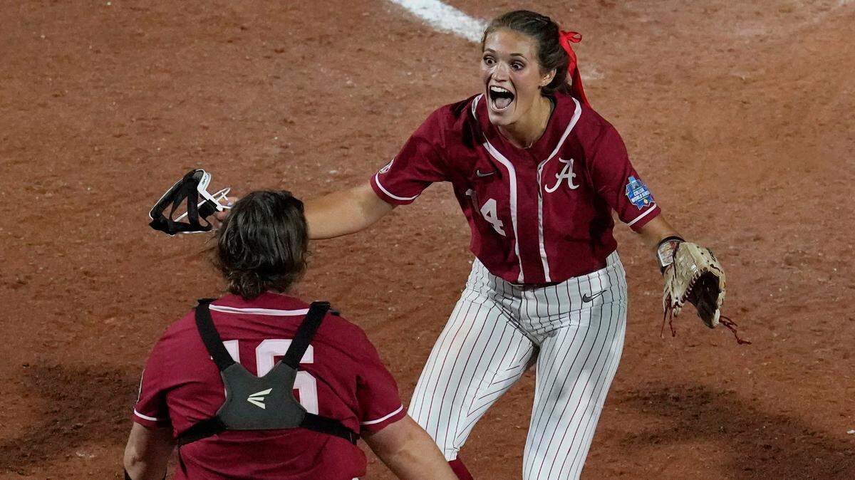 Alabama pitcher Montana Fouts, right, celebrates her perfect game with catcher Bailey Hemphill, after the team’s 6-0 win over UCLA in the Women’s College World Series on Friday night.