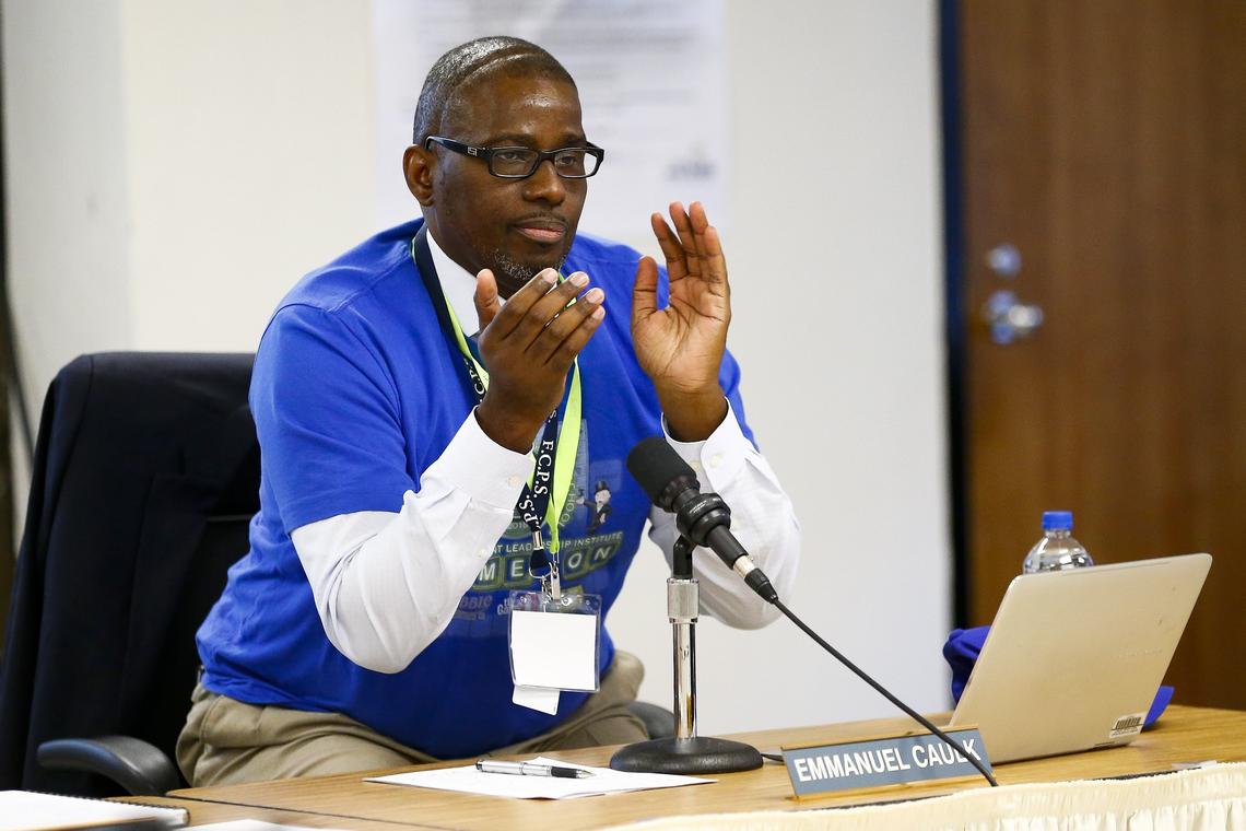 Superintendent Manny Caulk applauded at a school board meeting in July.
