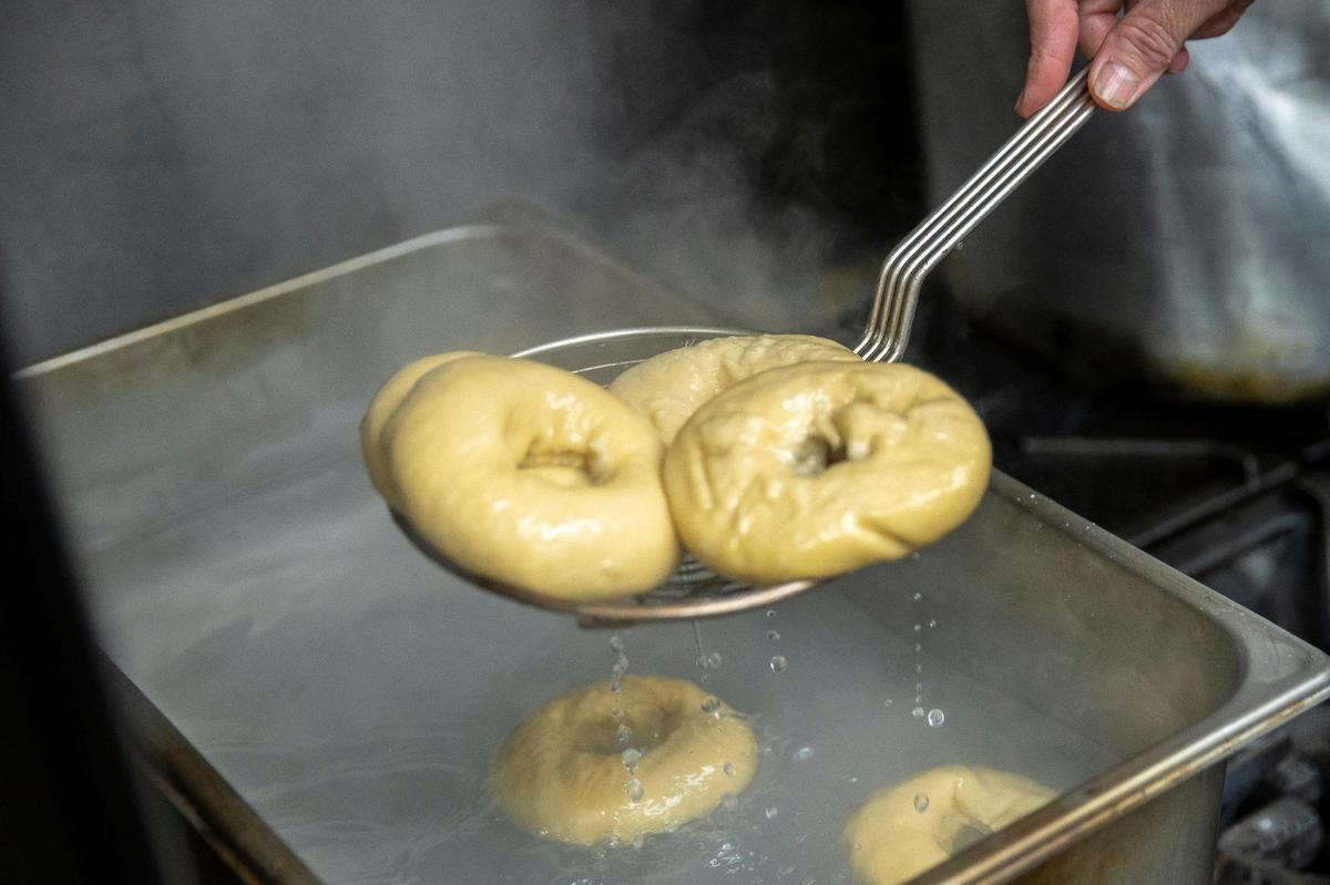 Baker Rhonda Patton boils bagels, rather than streaming them as some bakers do, before they’re baked June 9 at Native Bagel.