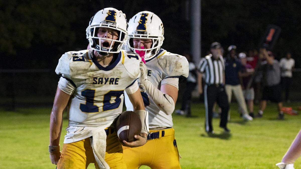 Sayre quarterback Gage Pennington (10) celebrates his fourthq-uarter touchdown run during the Spartans’ 34-20 win at Holy Cross High School in Louisville on Friday.