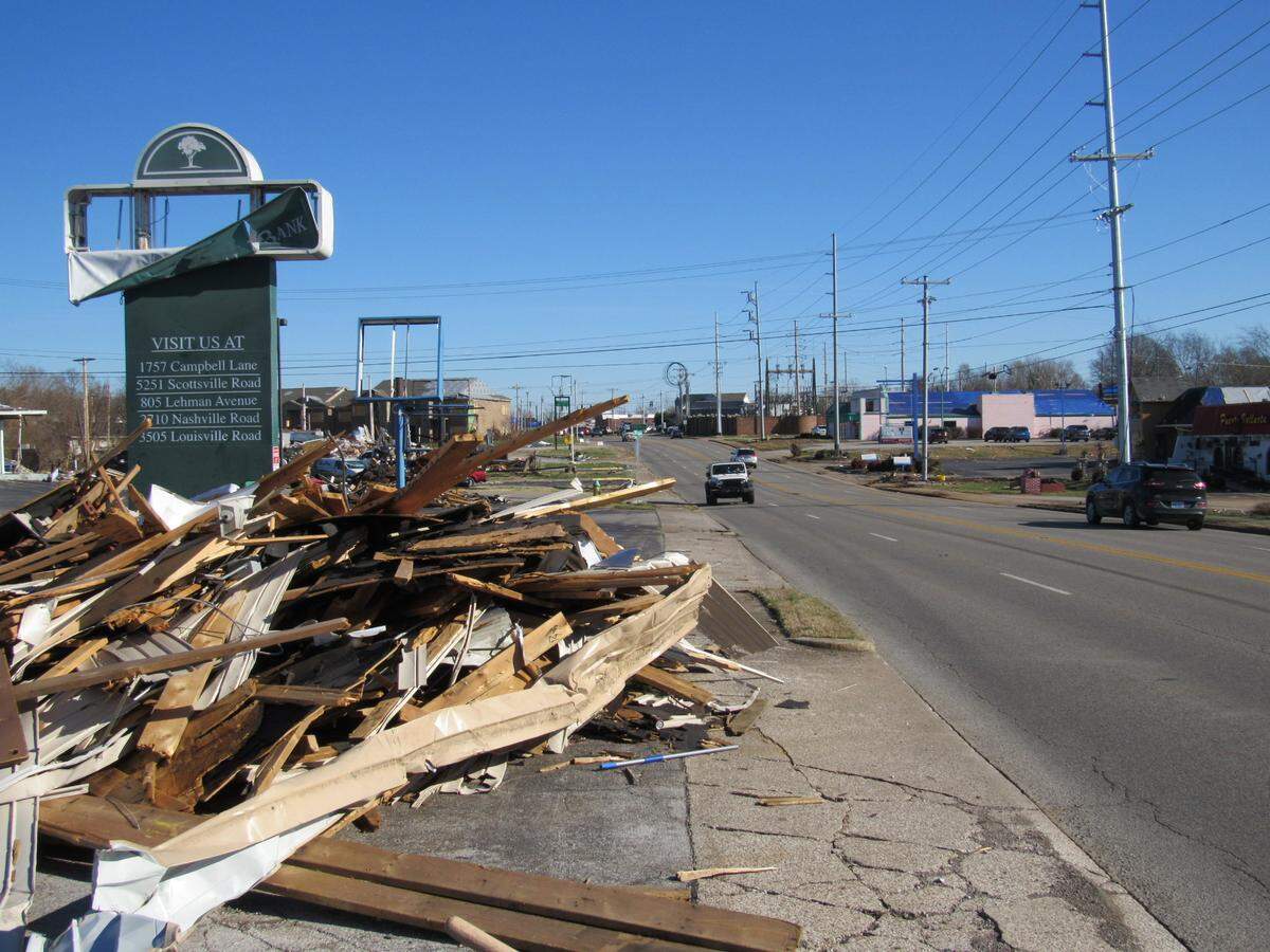 Debris from buildings damaged or destroyed in a Dec. 11 tornado in Bowling Green, Ky., remained piled along the 31W bypass, a busy retail corridor, on Jan. 4, 2022.