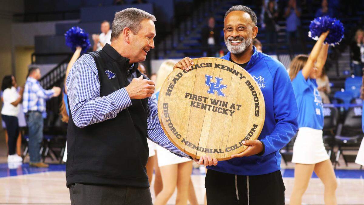 Kentucky coach Kenny Brooks, right, celebrates with athletics director Mitch Barnhart after his team’s season-opening win against USC Upstate on Monday night.