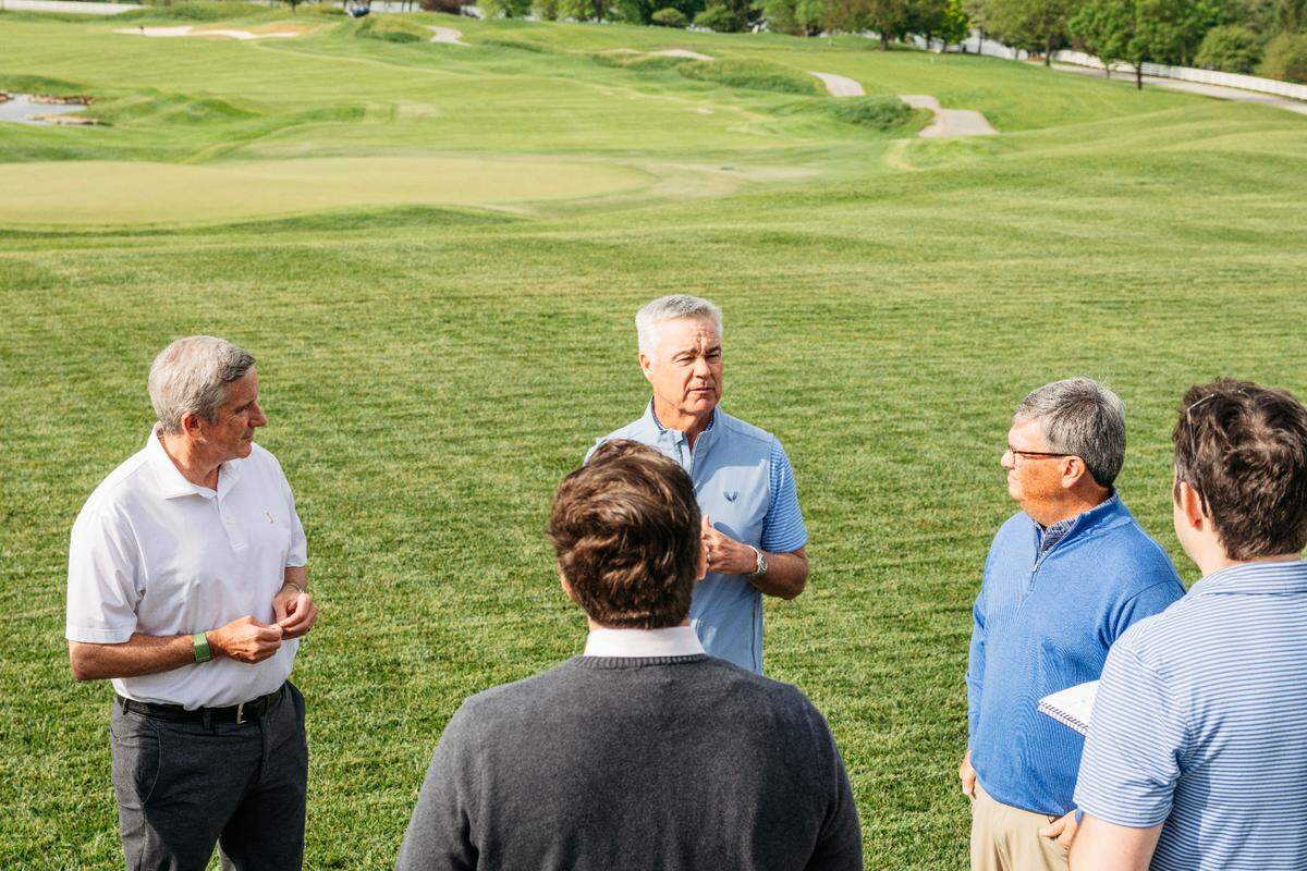 PGA Tour commissioner Jay Monahan, ISCO Industries chairman and CEO Jimmy Kirchdorfer and PGA Tour chief competitions officer Tyler Dennis (from left to right in the background) speak to media members on Friday at Valhalla Golf Club in Louisville.