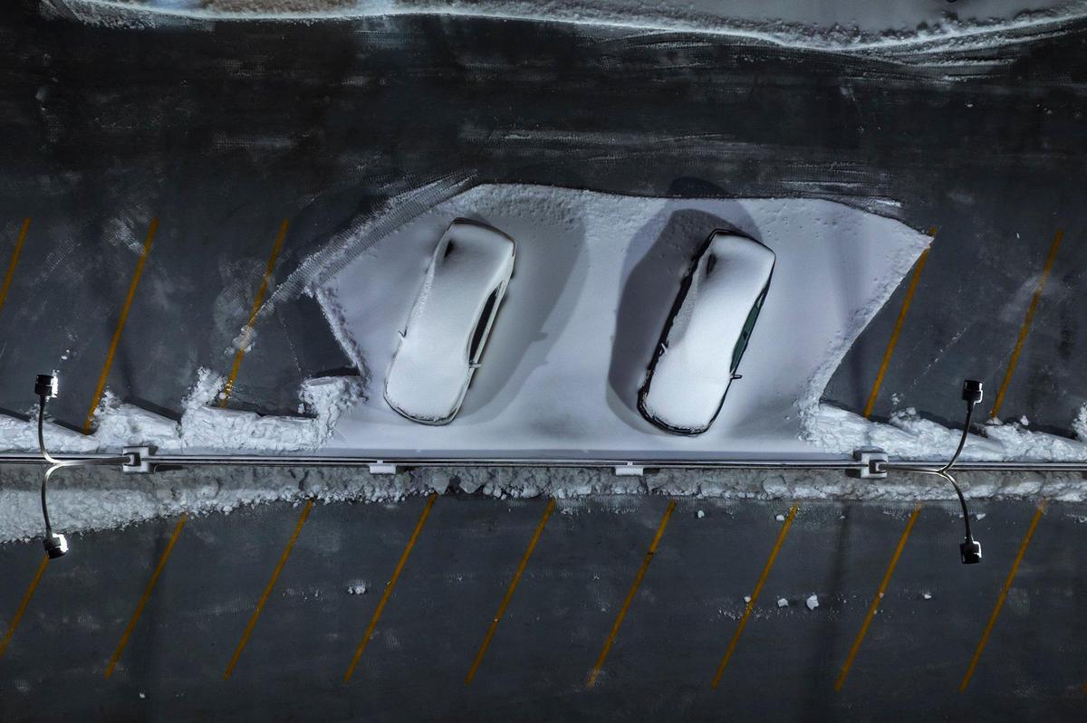 Snow covers vehicles parked at the Helix Garage in downtown Lexington, Ky., on Monday, Jan. 6, 2025.