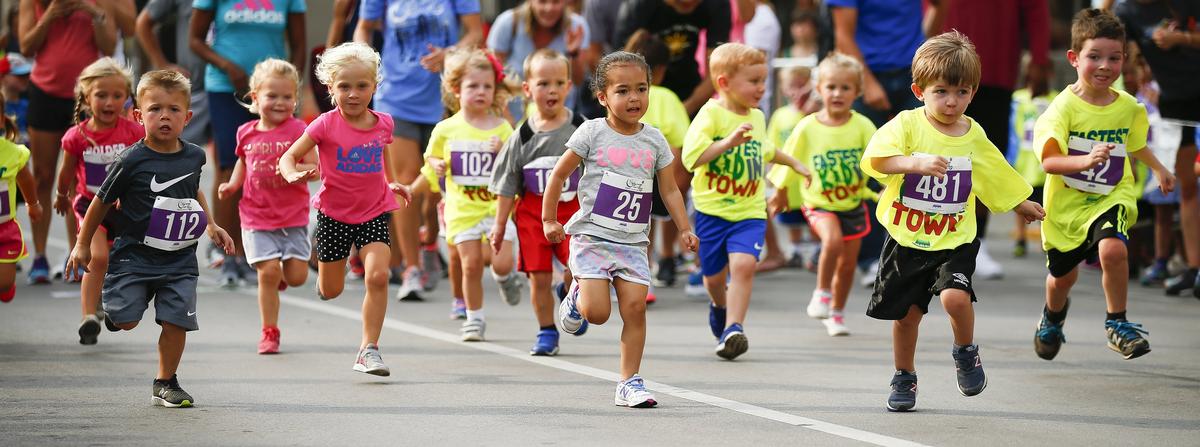 Runners in the three-year-old heat raced toward the finish line during the Fastest Kid in Town competition Saturday in downtown Lexington.