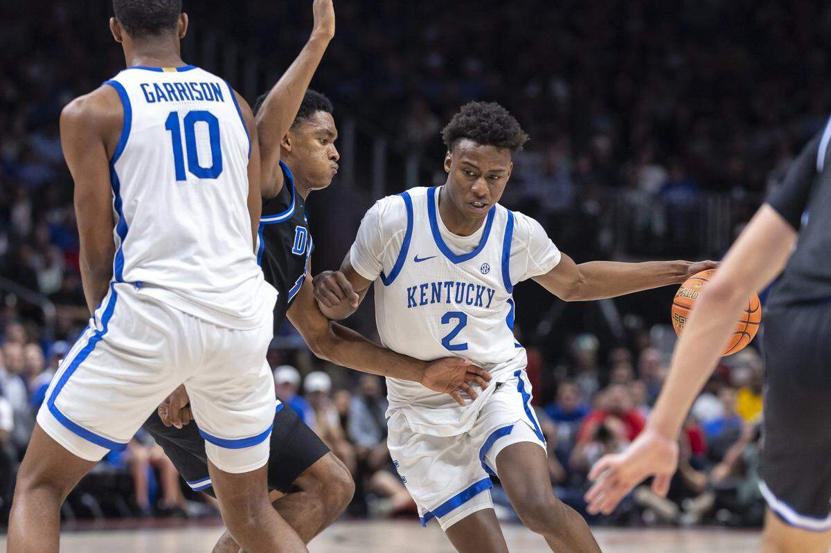 Kentucky guard Jaxson Robinson (2) drives the ball as Duke Blue guard Caleb Foster (1) defends during Tuesday’s game in the Champions Classic at State Farm Arena in Atlanta.