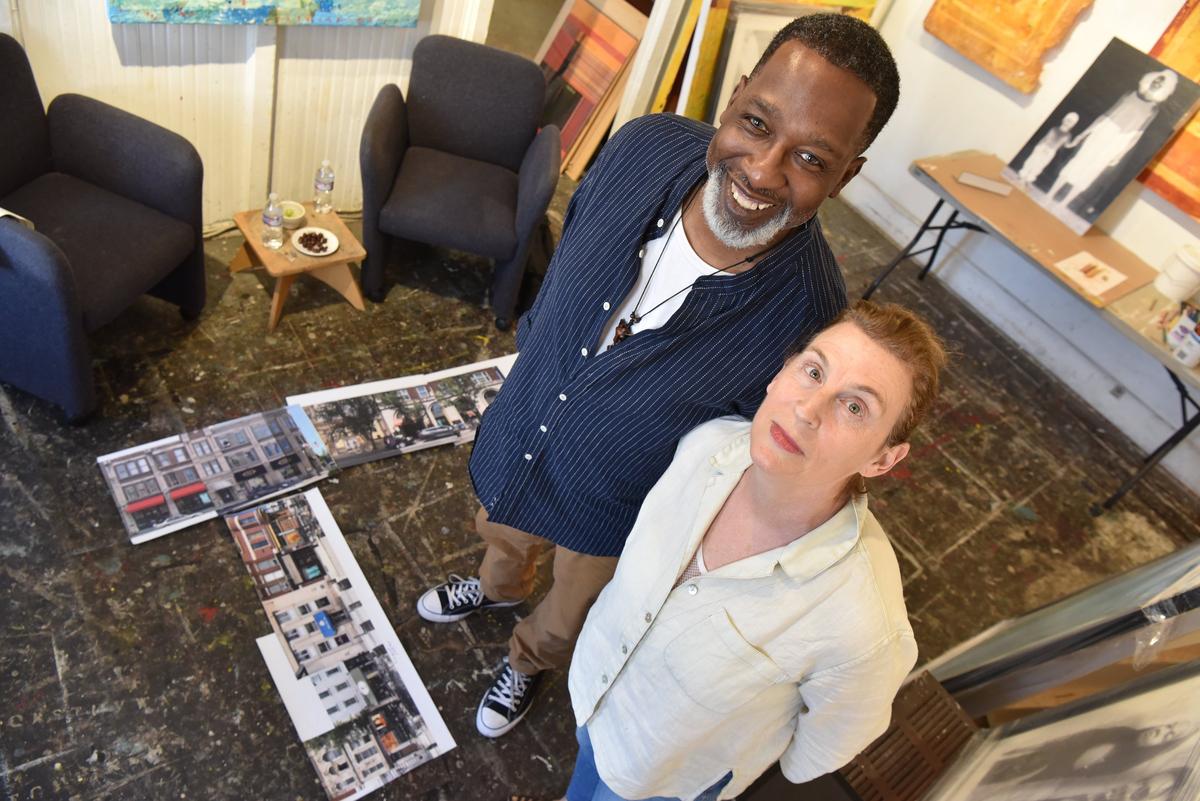 Artists Marjorie Guyon and Patrick J. Mitchell collaborated with poet Nikky Finney on “I Was Here,” a series of spirit portraits that will surround the former slave auction site of Cheapside in downtown Lexington in October. At their feet are photos depicting where the images will be displayed.