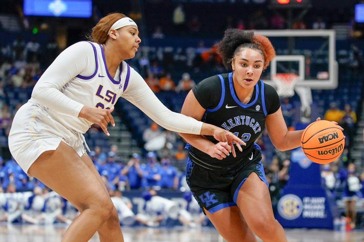 LSU’s Hannah Gusters, left, defends against Kentucky’s Treasure Hunt (12) on Friday night. Hunt scored 13 points for the Wildcats.