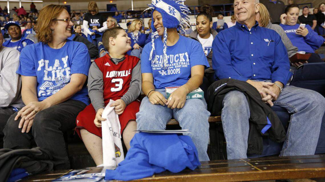 Trenton Pigg, 7, and his mom, Cheryl Pope, cheered for opposing teams during the UK-U of L women's game. "Here, pretty much you're blue or red," said UK women's soccer coach Jon Lipsitz.          