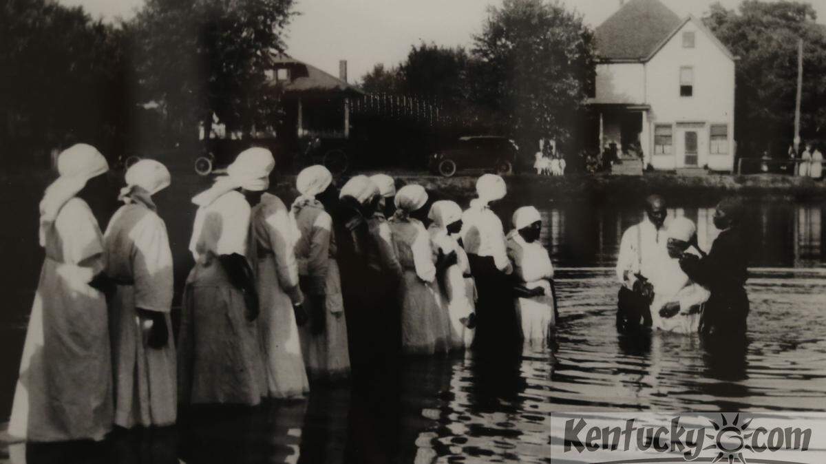 Baptism in pond circa 1919, is part of a historic photo exhibit of scenes from African American life at the University of Kentucky's King Library  on February 14, 2013 in Lexington, Ky. Photo by Mark Cornelison | Staff