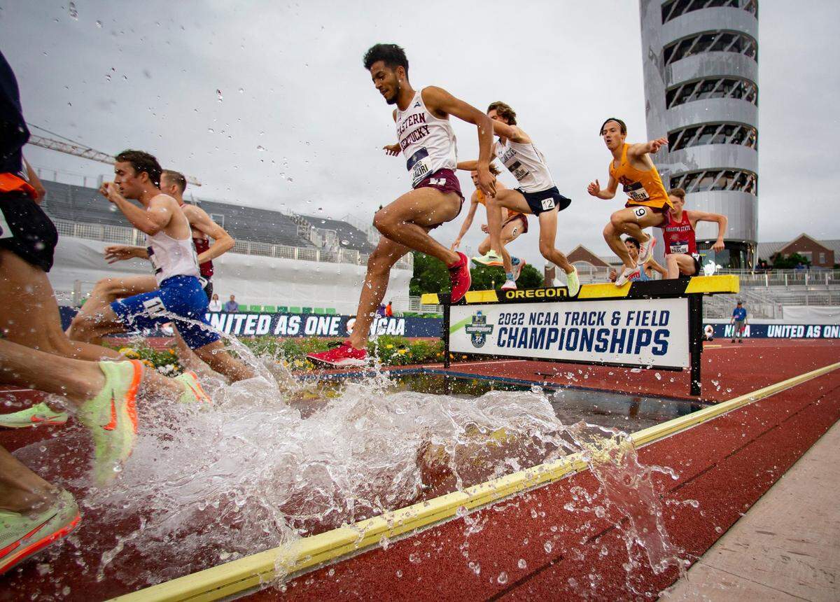 Eastern Kentucky's Ahmed Jaziri splashes through the water jump on his way to winning the men's 3,000 meter steeplechase on the third day of the NCAA Outdoor Track & Field Championships Friday, June 10, 2022 at Hayward Field in Eugene, Ore.