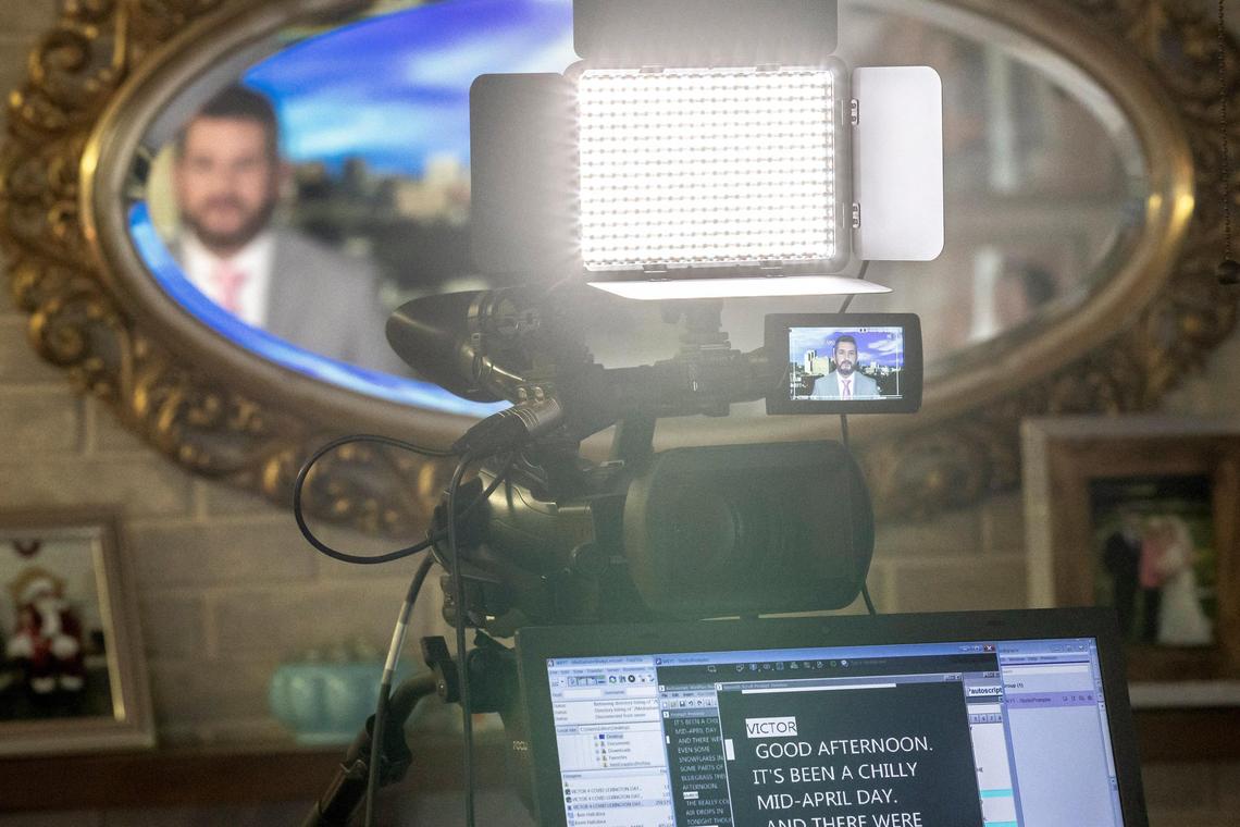 Victor Puente uses one set of chairs to hold up his laptop with the script he reads beneath his camera on a tripod.