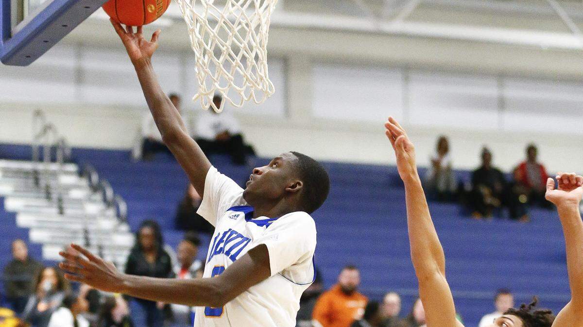 Henry Clay’s Marques Warrick (3) score past Frederick Douglass’ Jacob Kenney (0) during their game Tuesday at Henry Clay High School in Lexington. 