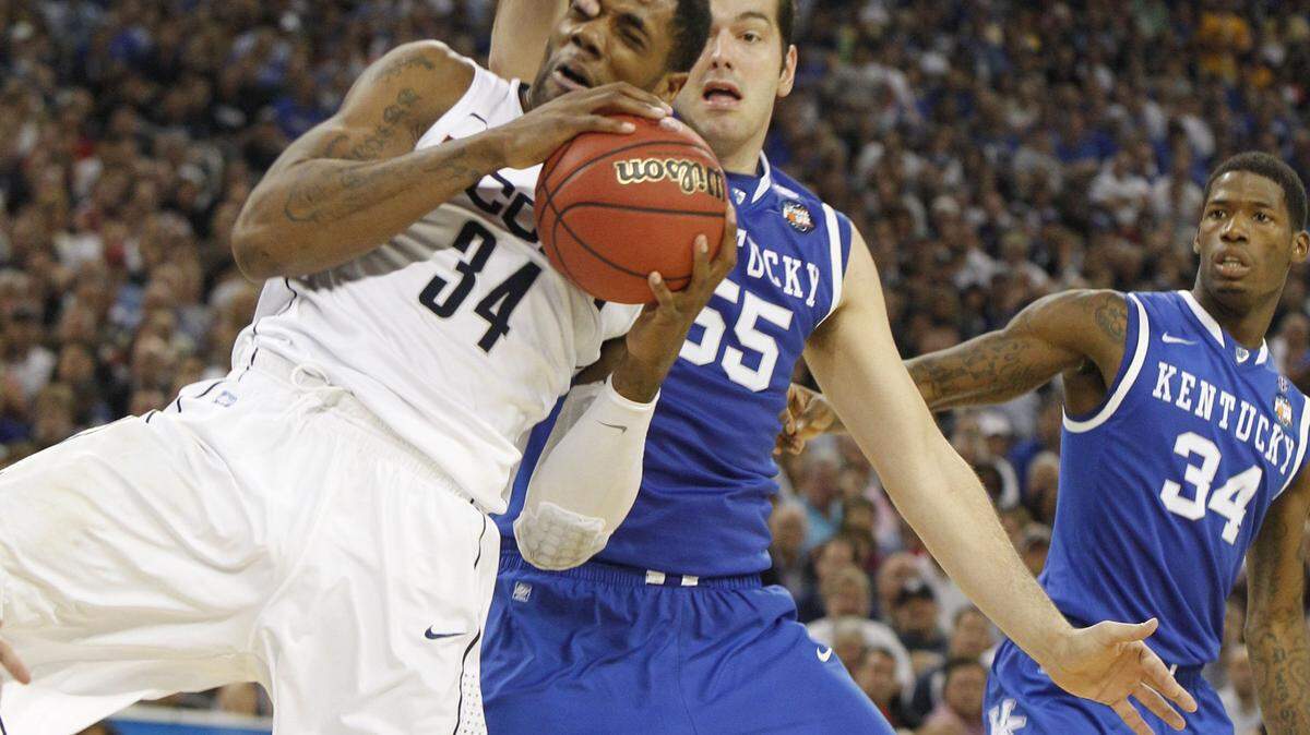 Kentucky senior Josh Harrellson battled Connecticut's Alex Oriakhi for the ball Saturday. After shooting 25-for-33 through the first four games, Harrellson went cold against Connecticut.  