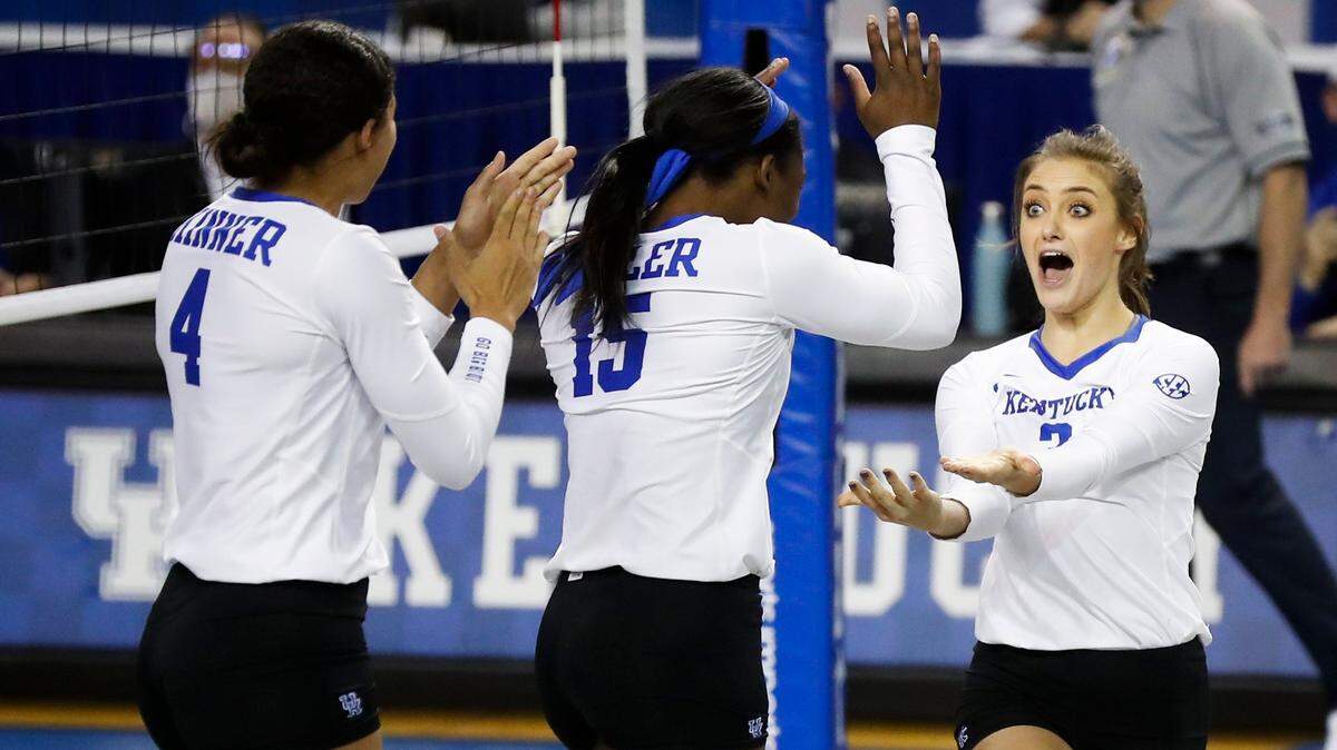 Kentucky’s Avery Skinner (4), Azhani Tealer (15) and Madison Lilley (3) celebrated during a match this season in Memorial Coliseum. The Wildcats wrapped up their regular season with a victory over Alabama on Thursday night to finish 19-1 and win their fourth consecutive Southeastern Conference championship.