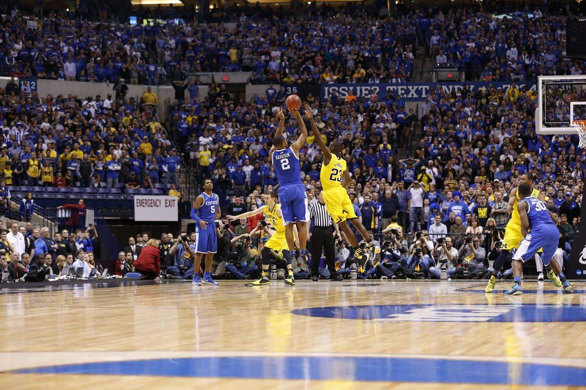 Kentucky Wildcats guard Aaron Harrison (2) hit the game-winning 3-pointer over Michigan Wolverines guard Caris LeVert (23)as the University of Kentucky played the University of Michigan in Lucas Oil Stadium in Indianapolis, In., Sunday, March 30, 2014. This is second half NCAA Midwest Regional finals action. UK won 75-72 to advance to the Final Four. Photo by Charles Bertram | Staff