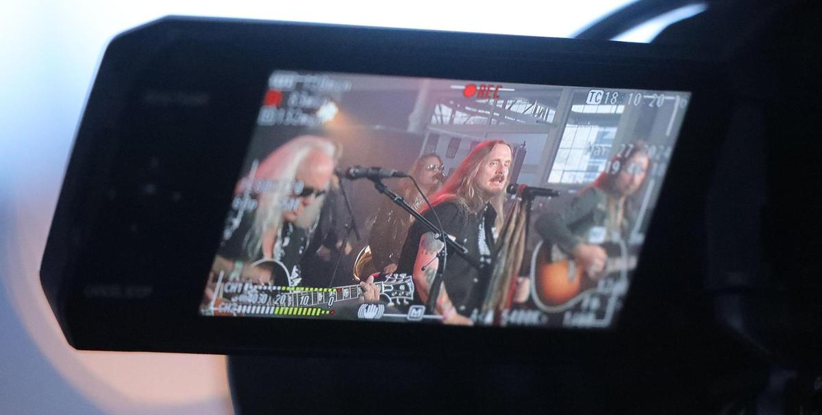 A fan takes a picture as legendary classic rock band Lynyrd Skynyrd plays an intimate concert at Greyline Station, celebrating the opening of the new Bespoken Spirits Distillery in Lexington, Ky on March 27, 2024.
