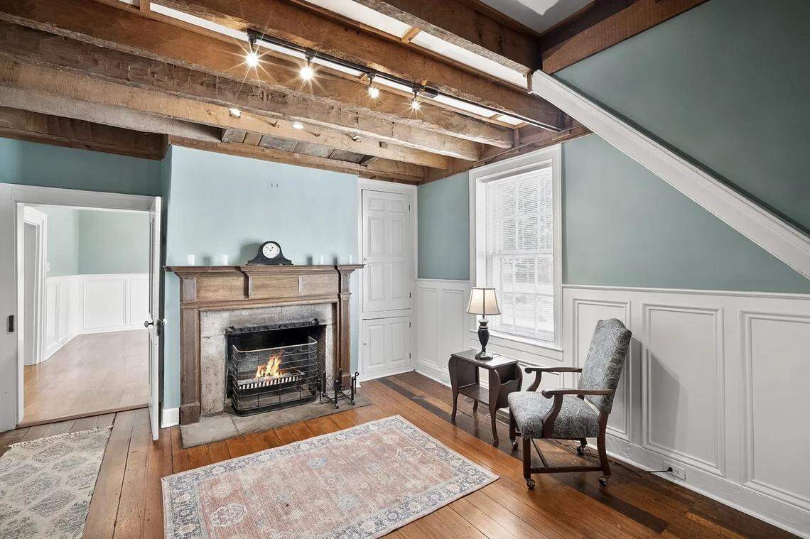 A view of the downstairs office with a fireplace at 315 Heritage Road.