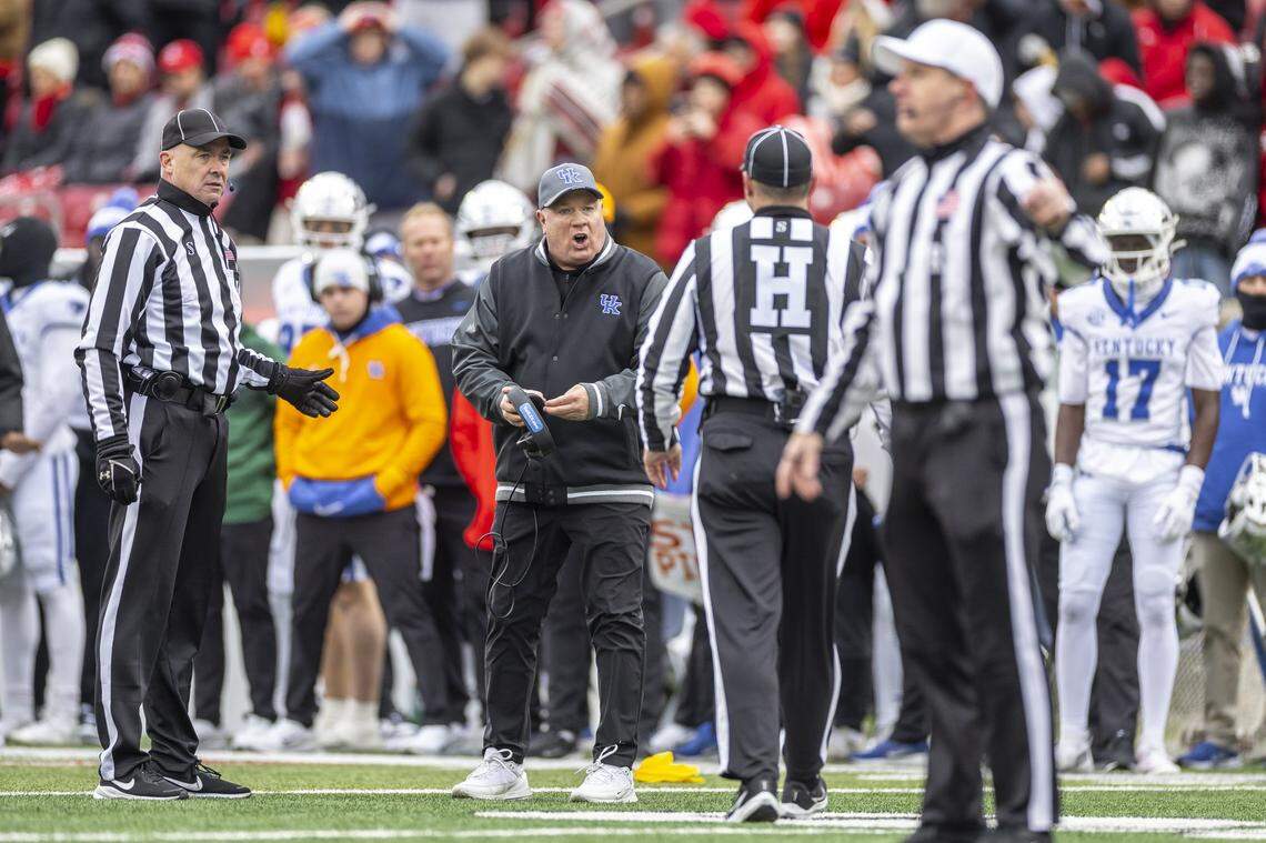 Kentucky head coach Mark Stoops talks to an official during the Governor’s Cup game against Louisville on Saturday.