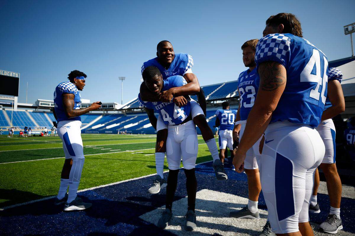Kentucky linebacker Jamin Davis (44) carried a teammate during Media Day activities at Kroger Field on Friday.