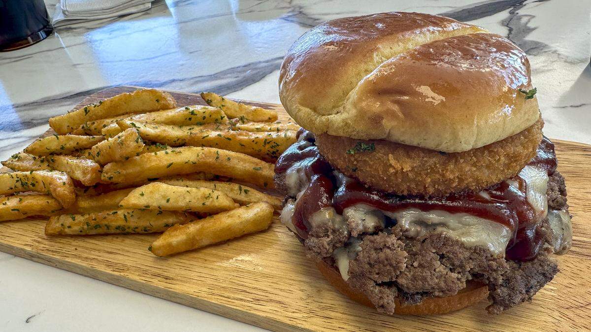 The We Be Grubbin’ burger at Bubba Grub, Oct. 27, 2024 in Nicholasville, Ky. The burger, served with french fries, is topped with bourbon barbecue sauce, house-made bourbon bacon jam, pepper jack cheese and a house-made onion ring on a toasted bun.