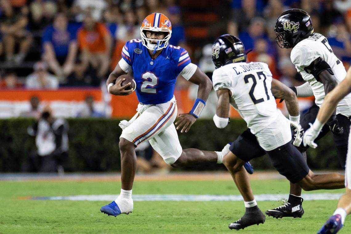 Oct 5, 2024; Gainesville, Florida, USA; Florida Gators quarterback DJ Lagway (2) scrambles past UCF Knights defensive back Chasen Johnson (27) and UCF Knights defensive end Malachi Lawrence (51) during the second half at Ben Hill Griffin Stadium. Mandatory Credit: Matt Pendleton-Imagn Images