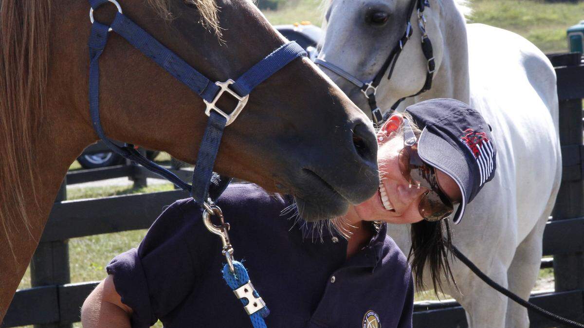 Lindsay Graham of Napa, Calif., got a playful nudge from her Arabian horse, Monk, as they posed for the media Thursday at Shaker Village of  Pleasant Hill. Graham is with the U.S. endurance team, which is training at Shaker Village for three weeks leading up to the World Equestrian Games. 