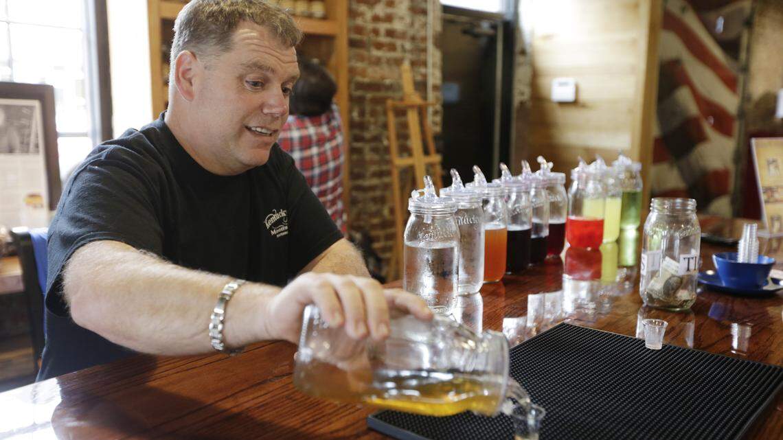 Owner Colin Fultz poured samples of his flavored moonshine at Kentucky Mist moonshine distillery in Whitesburg. The still and many of the moonshine ingredients come from Kentucky.