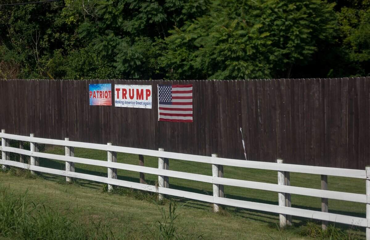 A fence with a sign supporting President Trump pinned to it in Madison County, Ky., Thursday, August 6, 2020.