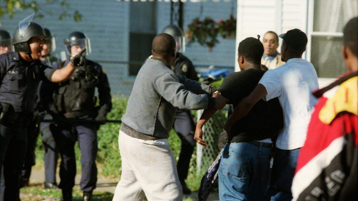 Lexington police confronted black youths returning from a march to city hall in October 1994. More than 100 protested the fatal shooting of Tony Sullivan by a white officer.