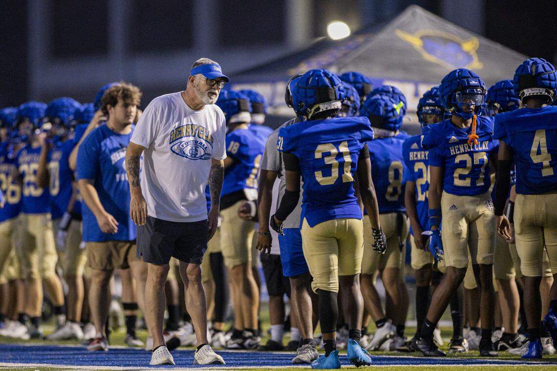 Henry Clay head coach Phillip Hawkins talks with his players during a football scrimmage on Friday, Aug. 8, 2025, at Henry Clay High School in Lexington, Ky.