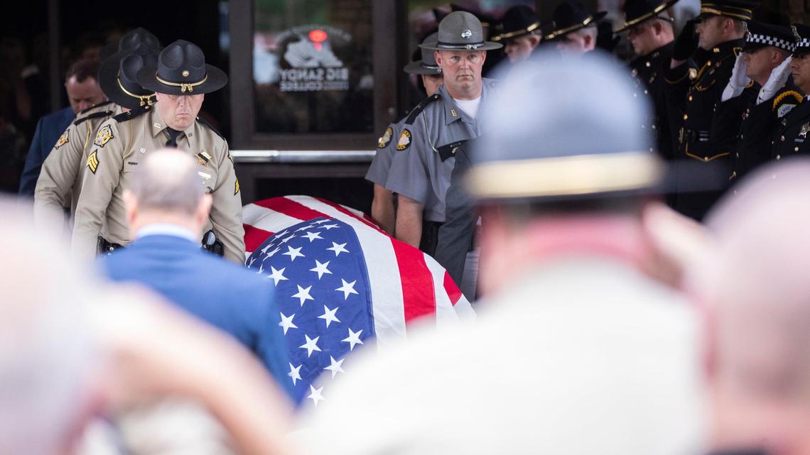 Law enforcement officers carry the casket of Floyd County Deputy William Petry to the hearse after the funeral service at the Mountain Arts Center in Prestonsburg, Ky., Tuesday, July 5, 2022.