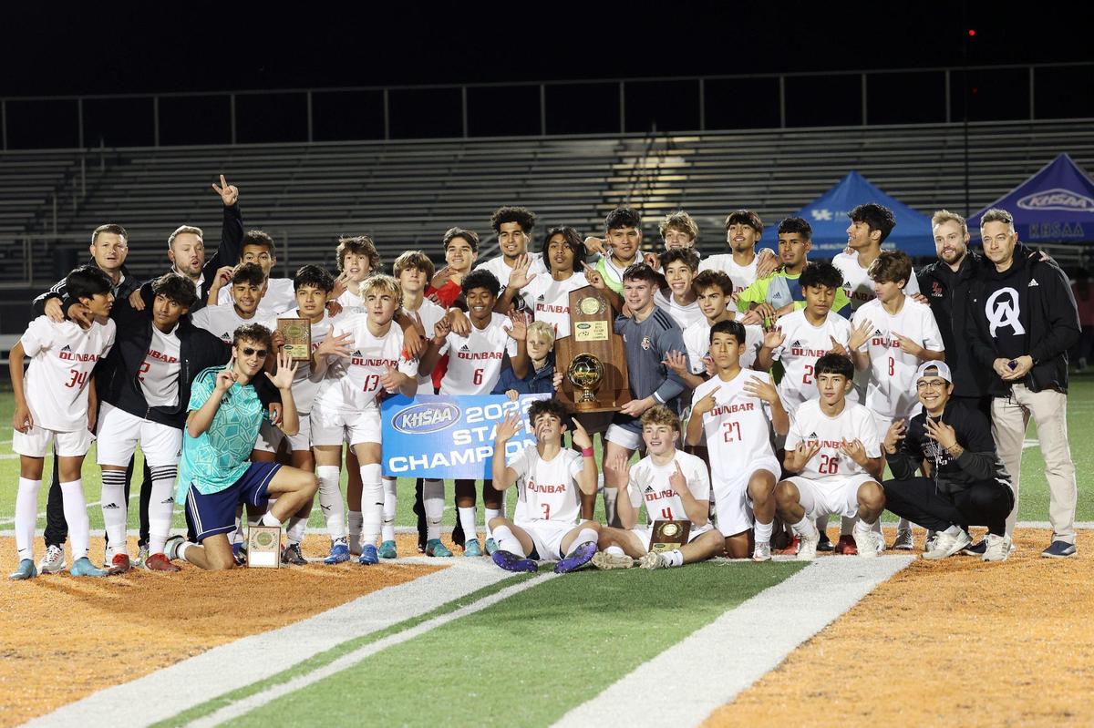 Paul Laurence Dunbar’s team poses with the KHSAA Boys’ State Soccer Championship trophy after defeating St. Xavier 1-0 (4-2 on penalty kicks) at Frederick Douglas High School in Lexington on Saturday night.