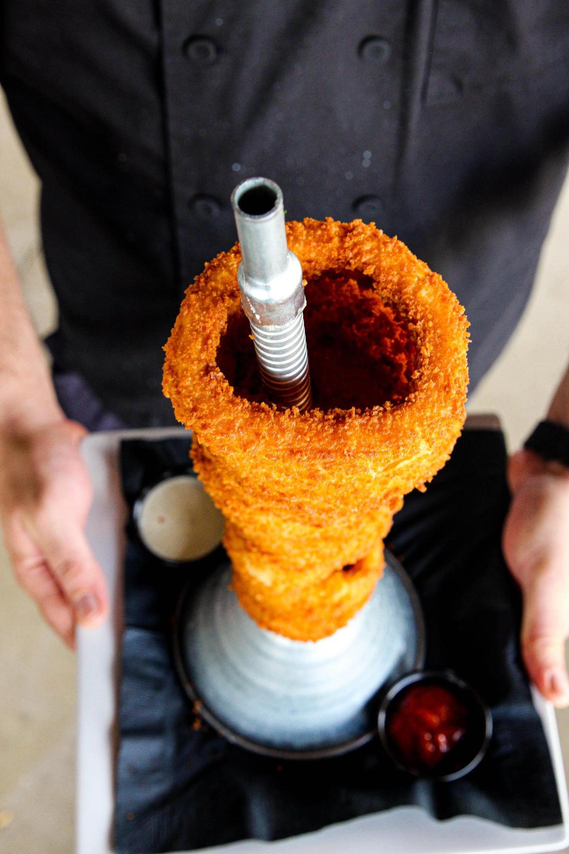 The Giant Funnel Tower of Jumbo Piston Onion Rings appetizer ($12.99) from Ford’s Garage is served with house-made chipotle ketchup and Hidden Valley Ranch.