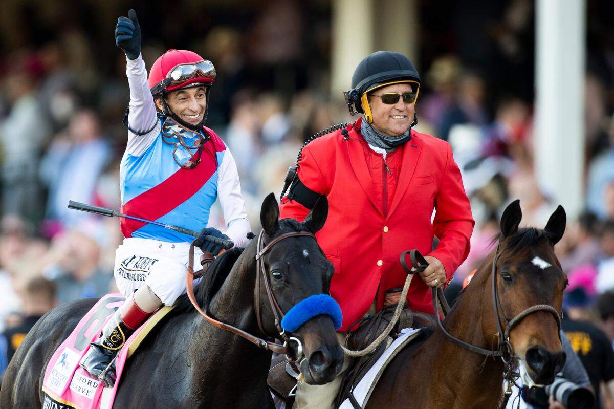 John R. Velazquez celebrates atop Medina Spirit (8) after winning the 147th Kentucky Derby at Churchill Downs last May. On Monday, racing stewards disqualified Medina Spirit’s victory based on a positive postrace drug test.