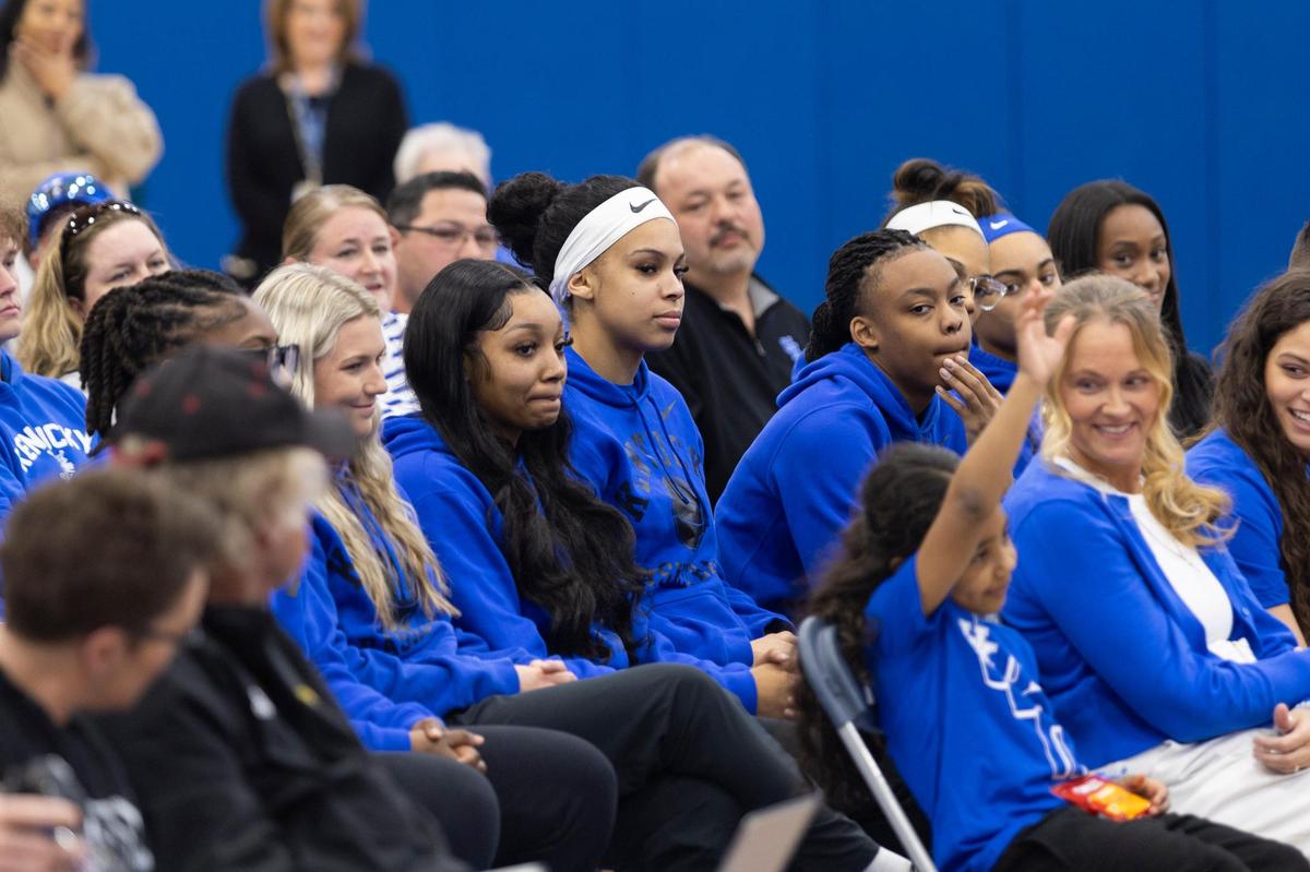 Members of the Kentucky women’s basketball team watch athletic director Mitch Barnhart and Kenny Brooks during the coach’s introductory press conference Thursday.