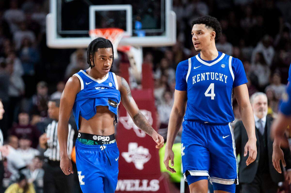 Kentucky’s Rob Dillingham, left, and Tre Mitchell walk off the court during a timeout in overtime of the Wildcats’ loss to Texas A&M on Saturday in College Station.