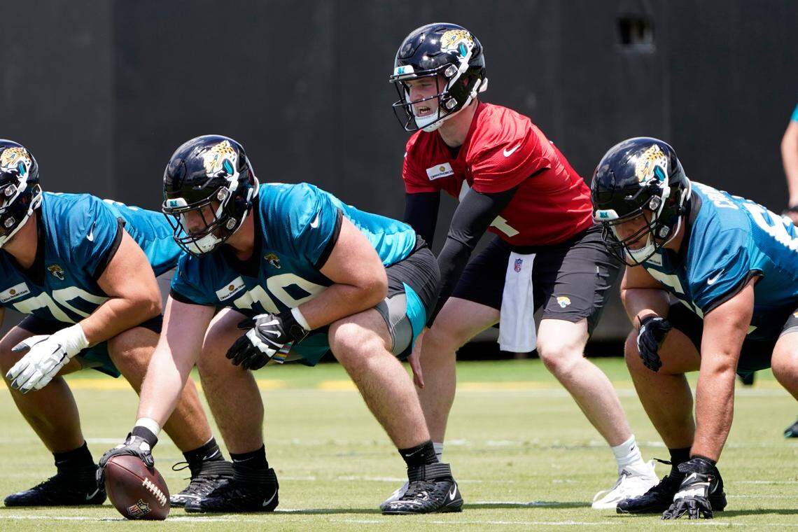 Jacksonville Jaguars center Luke Fortner front left, snaps the ball to quarterback E.J. Perry during NFL football rookie minicamp, Friday, May 13, 2022, in Jacksonville, Fla.