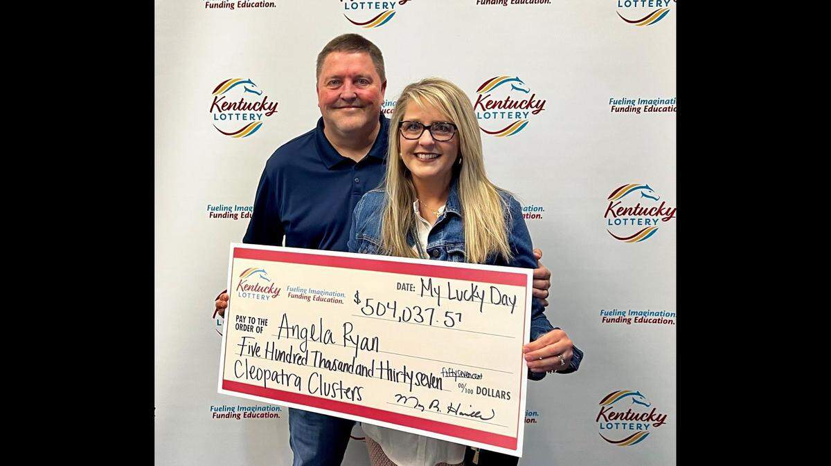 Angela Ryan of Ashland, Ky., poses with her husband, Reece, and a big check after winning more than $504,000 through an instant-win lottery game recently.