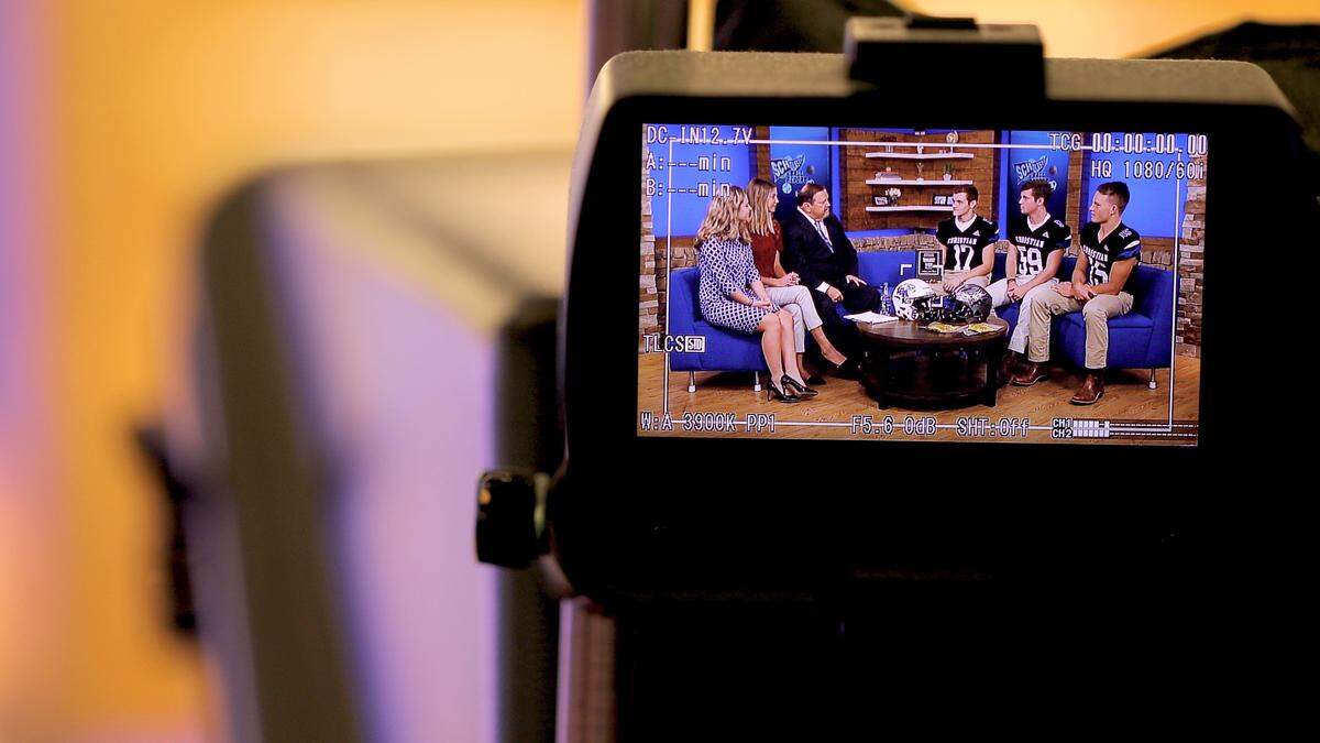 Producer Gary Ball spoke to football players from Lexington Catholic next to two interns, Karson Purdy and Grace Hager, during a production of “Scholastic Ball Report” at WKYT’s studios.