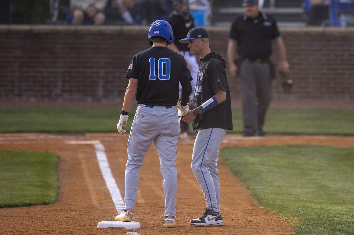 Lexington Christian Academy head coach Seth Knight talks with Jackson Gier during a game at Paul Laurence Dunbar High School in Lexington, Ky., on Tuesday, April 21, 2026.