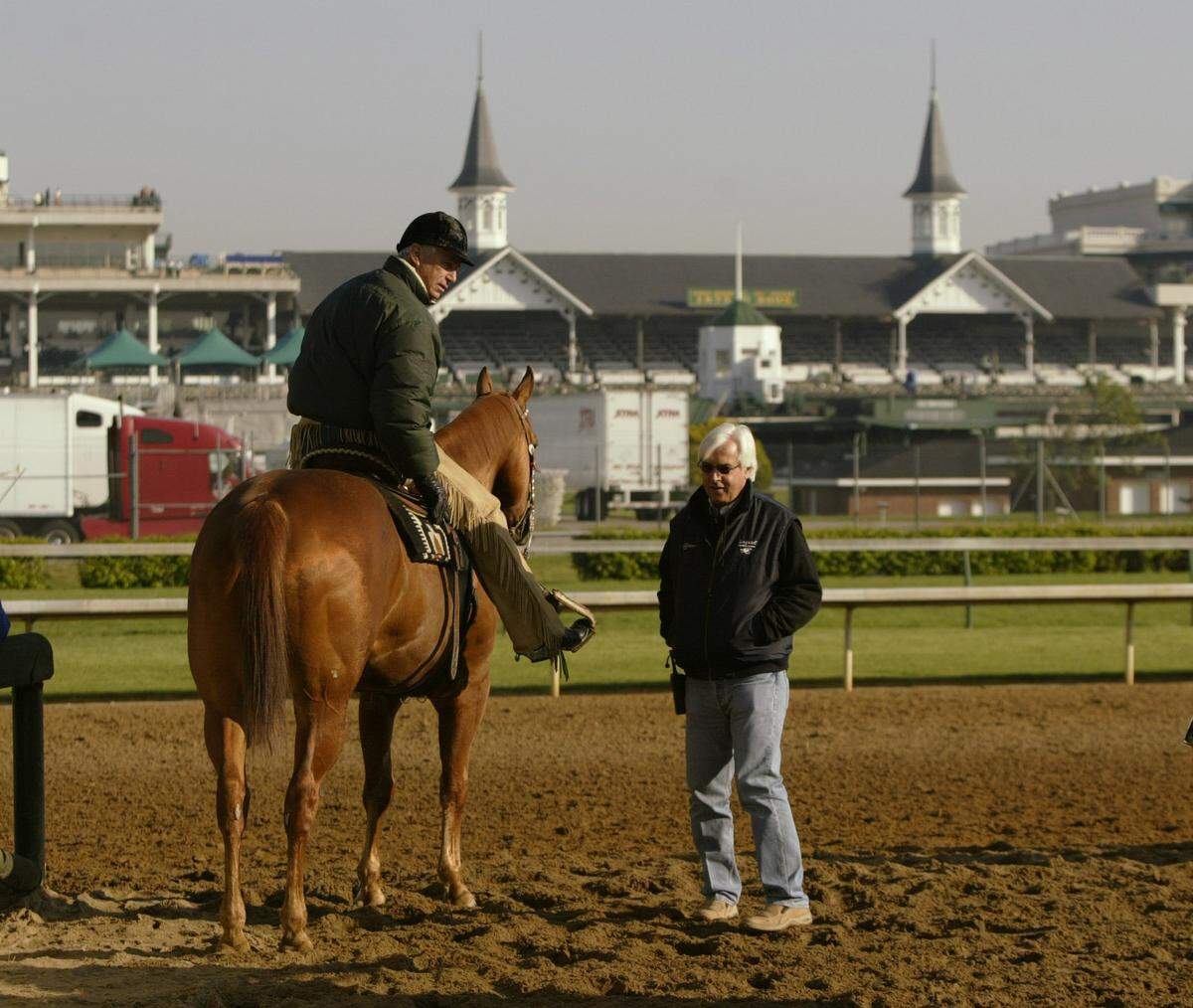 Trainers D. Wayne Lukas, left, and Bob Baffert talk with each other while they wait for their horses to return from a morning training at Churchill Downs in Louisville prior to the 131st Kentucky Derby on May 4, 2005.
