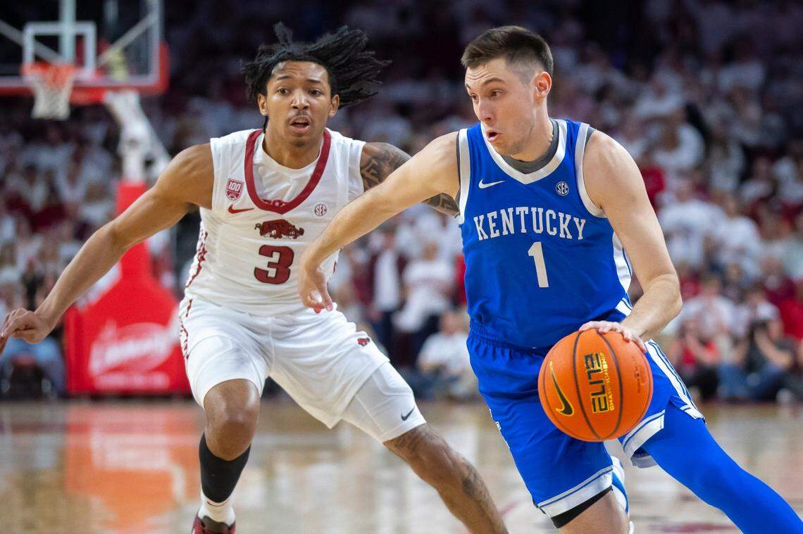 Kentucky guard CJ Fredrick (1) drives the ball past Arkansas guard Nick Smith Jr. during a game at Bud Walton Arena in Fayetteville on March 4.